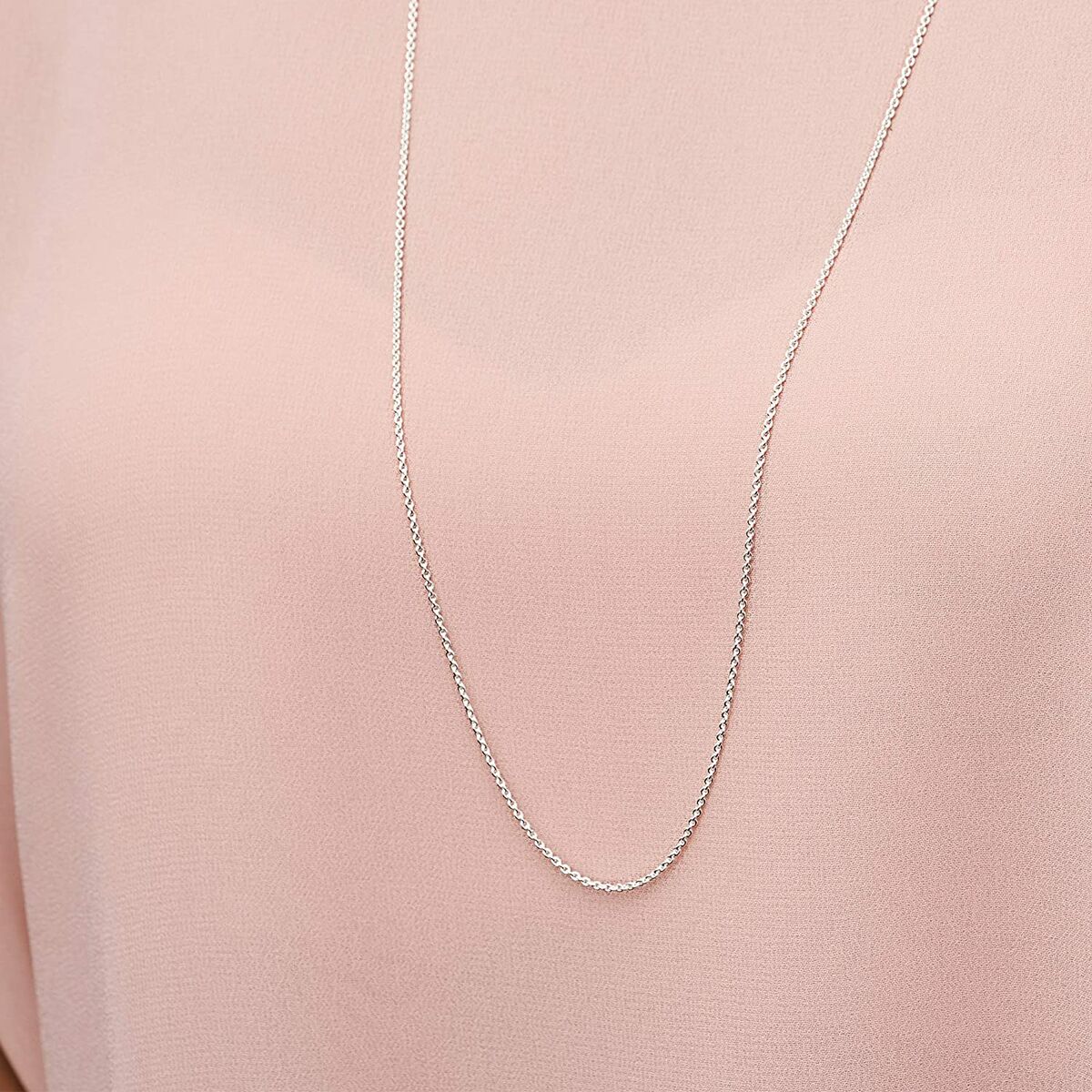 Zilverkleurige Pandora ketting, elegant detail zichtbaar op een roze blouse.