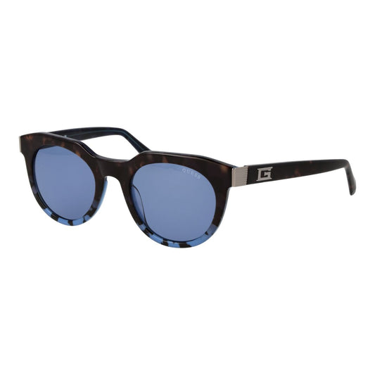 Guess zonnebril uniseks met cirkelvormig design en blauwe glazen, zijaanzicht.