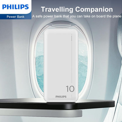 Witte Philips Powerbank DLP1810NW/62 op een tafel bij een vliegtuigraam.