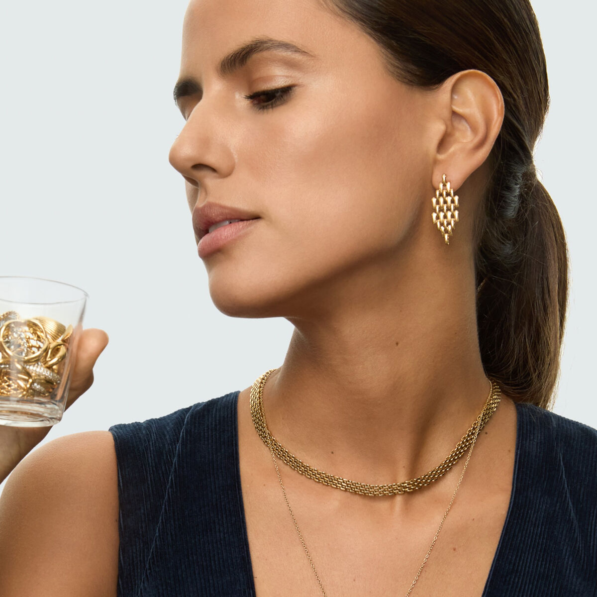 Detail van de One Jewels gouden oorbellen, elegant ontwerp aan het oor van een model.