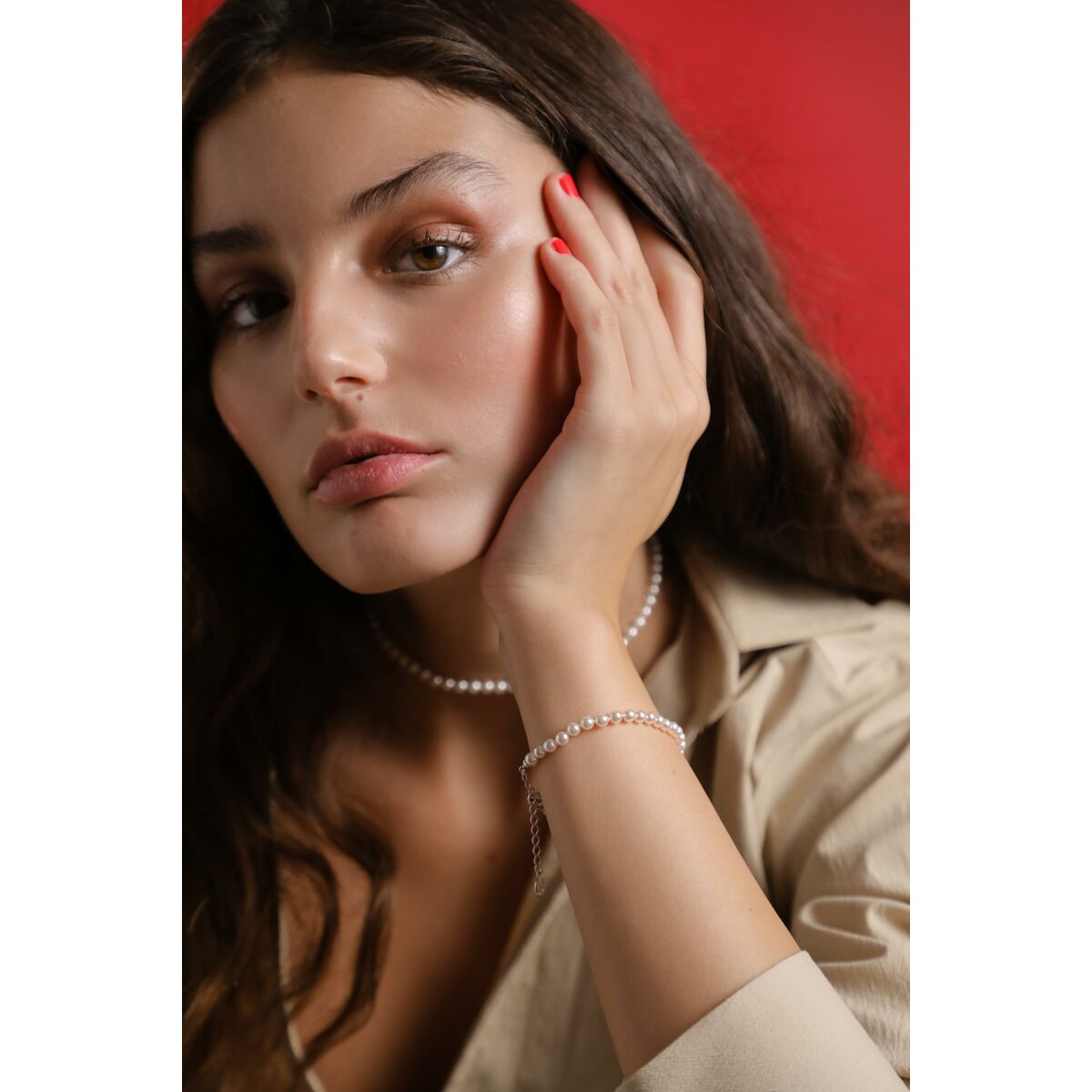 Zilverkleurige Majorica armband elegant gedragen om de pols met parelachtige details.
