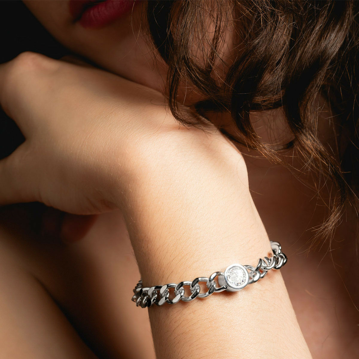 Detail van de zilverkleurige Lotus armband met een ronde hanger, elegant om de pols.