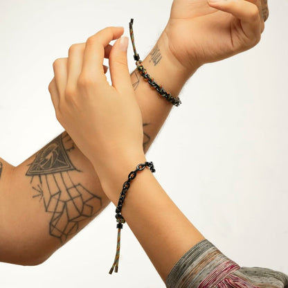 Detail van de Lotus armband met kleurrijke schakels, gedragen om een pols.
