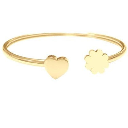 Gouden CO88 Collection armband voor dames met hart- en bloemvormige details.