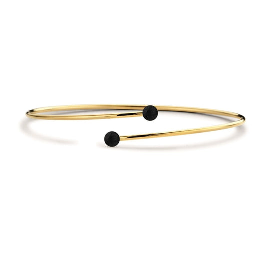 Stijlvolle gouden CO88 Collection armband met zwarte accentbolletjes en een elegante, open vorm.