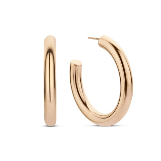 Elegante oorbellen van CO88 Collection in roze goud met een unieke, gebogen vorm.