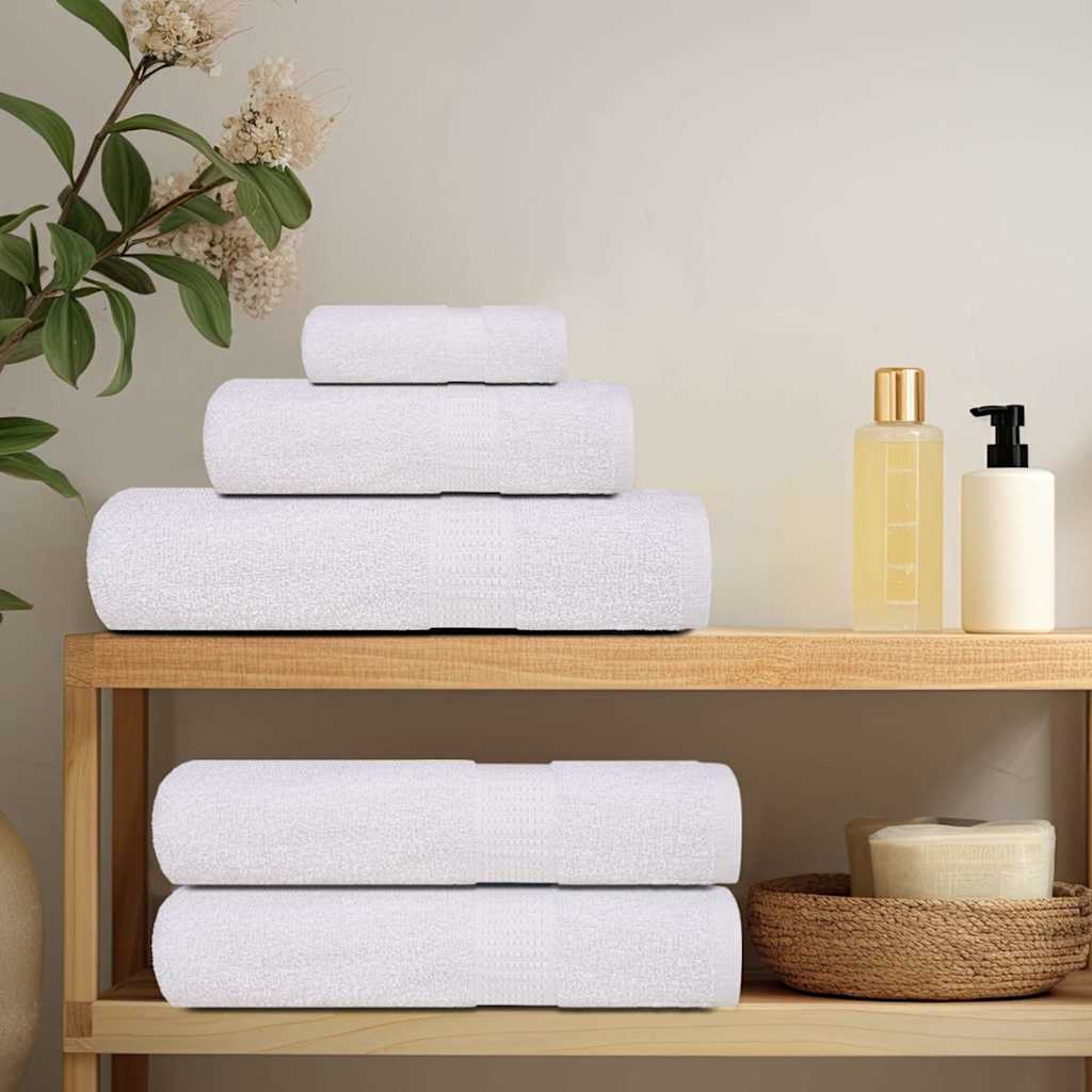 Witte vidaXL FROGN washandjes gestapeld op een houten plank met verzorgingsproducten.