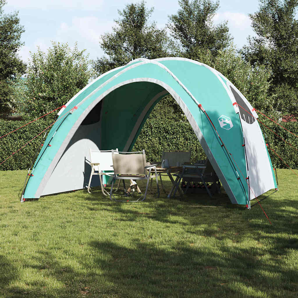 Detail van de vidaXL partytent in groen, met opzet en stoelen eronder.