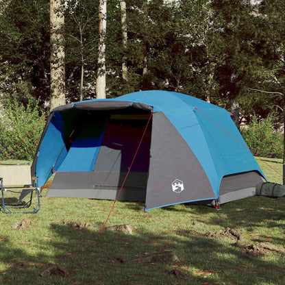Zijaanzicht van de vidaXL 4-persoons tent met luifel in blauw, geplaatst op gras.