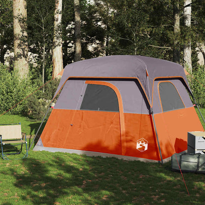 Zijaanzicht van de vidaXL 4-persoons tent in oranje met grijze accenten, geplaatst op gras.