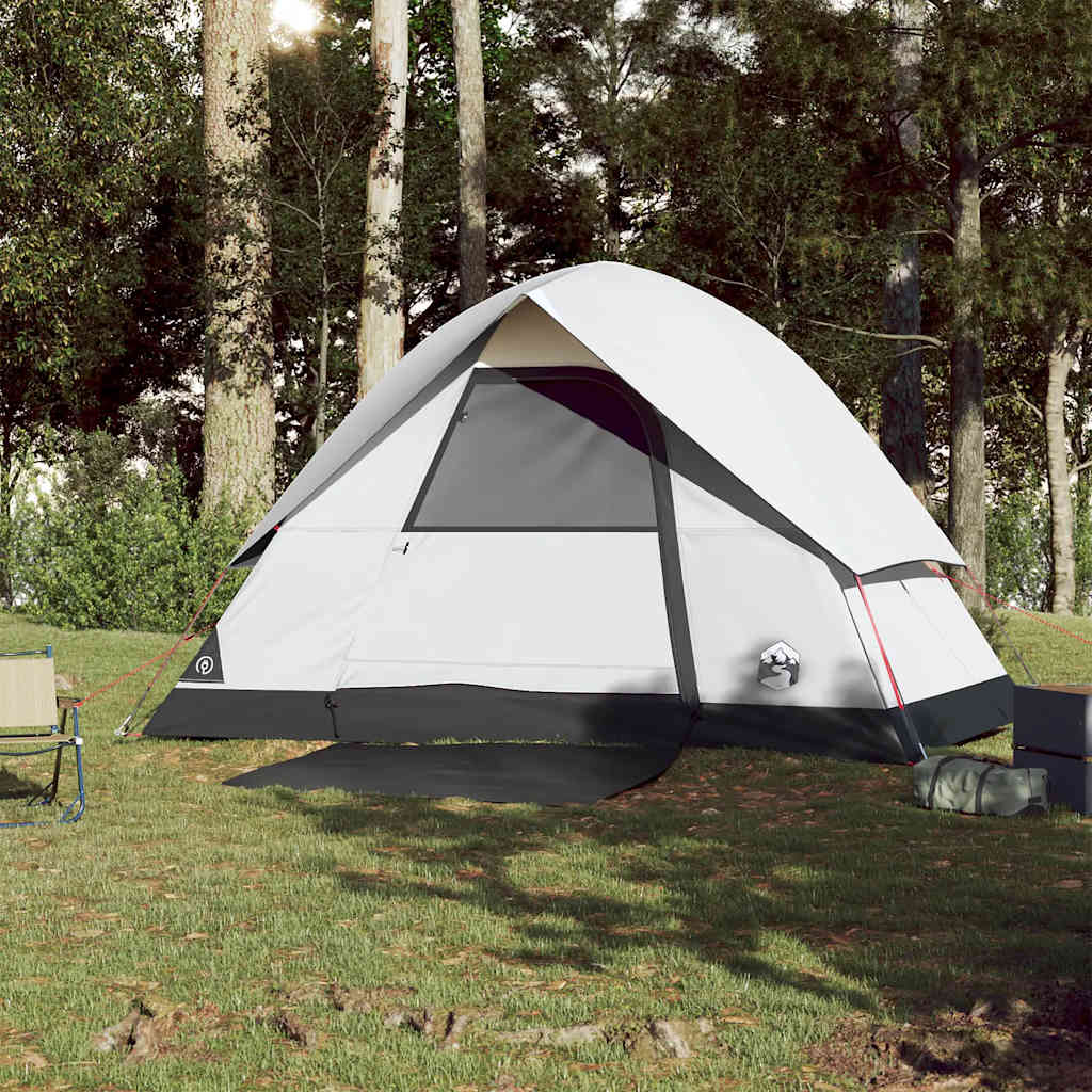 Zijaanzicht van de vidaXL koepeltent in wit, opgesteld op gras met kampeerstoelen.