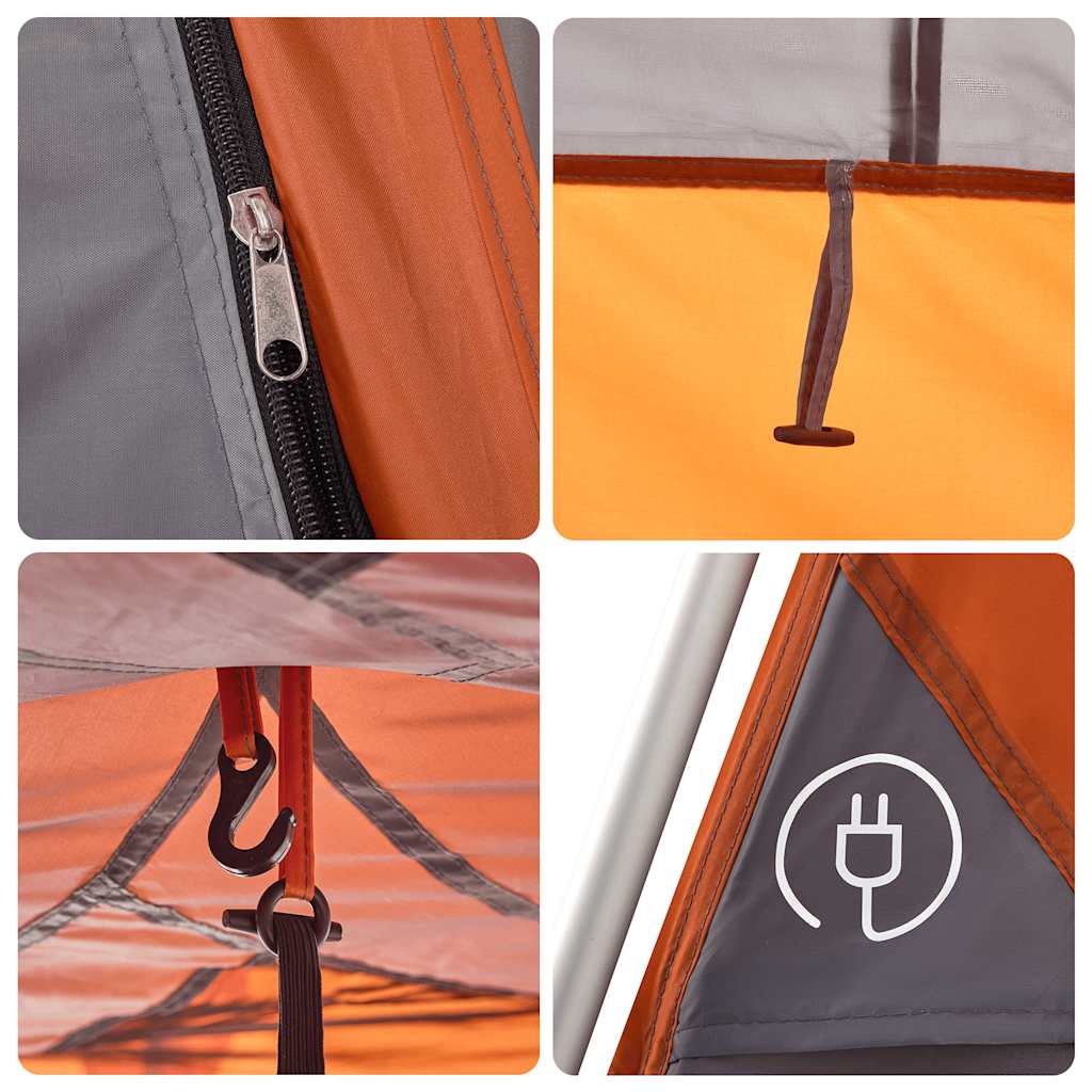 Detail van de grijze en oranje koepeltent met rits en bevestigingshaken.