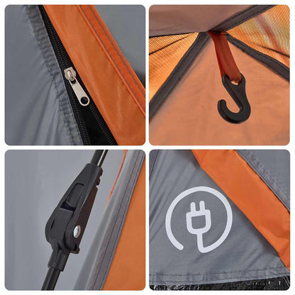 Detail van de grijze en oranje koepeltent met rits, haak en bevestigingsmechanisme.