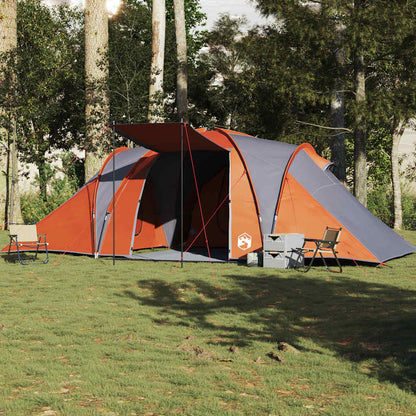 Zijaanzicht van de vidaXL koepeltent in grijs en oranje, opgesteld op gras met stoelen.