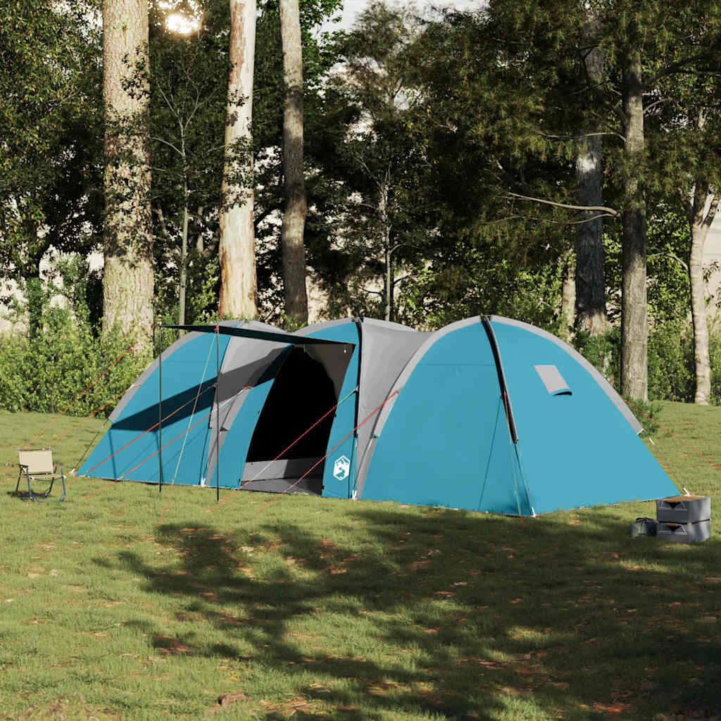 Zijaanzicht van de vidaXL koepeltent in blauw, opgesteld in een groene omgeving.