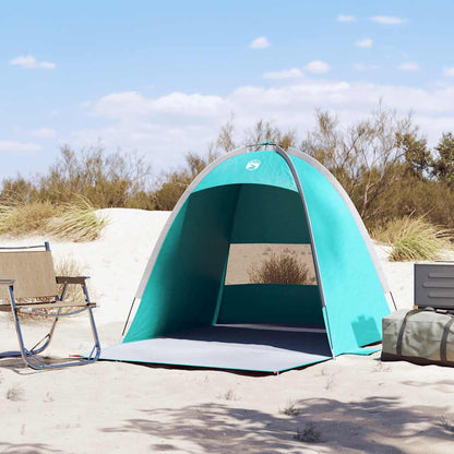 Zijaanzicht van de vidaXL strandtent in zeegroen, met open ingang en zand op de achtergrond.