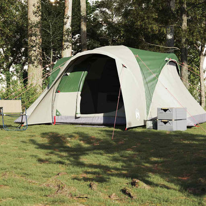 Zijaanzicht van de vidaXL koepeltent in groen, opgesteld op gras met campingstoelen.