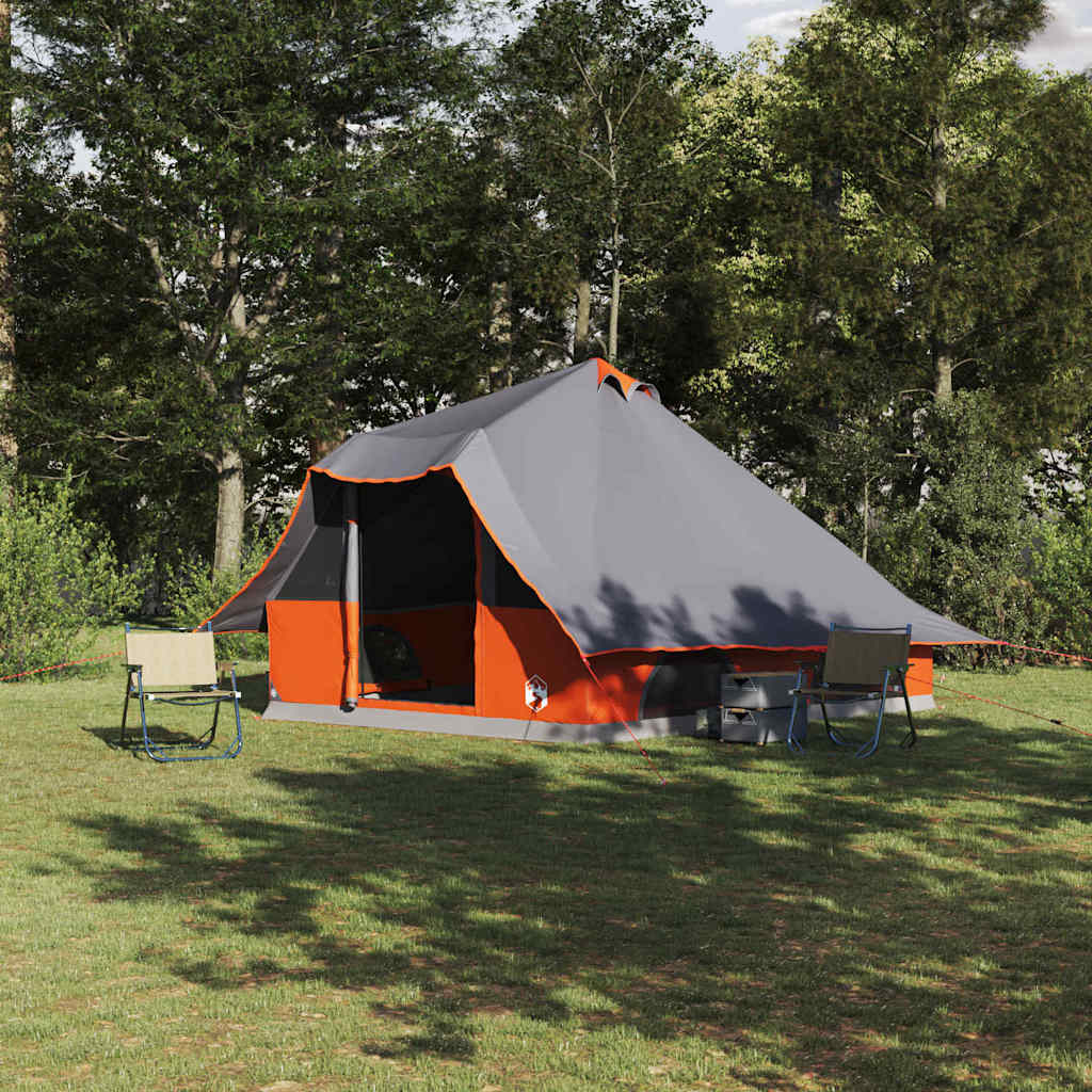 Grijze en oranje vidaXL Tipi Tent in een groene omgeving met twee campingstoelen.