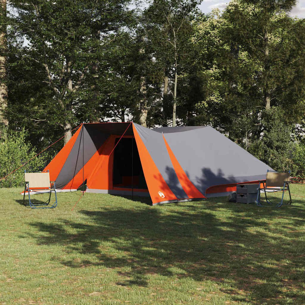 vidaXL Tipi Tent in grijs en oranje, geplaatst op gras met stoelen en een tafel.