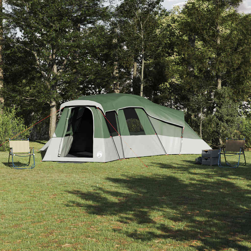 VidaXL gezinstent met dak in groen, geplaatst op gras met campingstoelen ernaast.