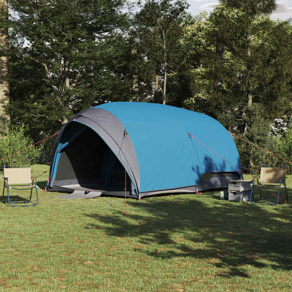 Blauwe vidaXL tunnel tent met opslag, geplaatst in een groene omgeving met campingstoelen.