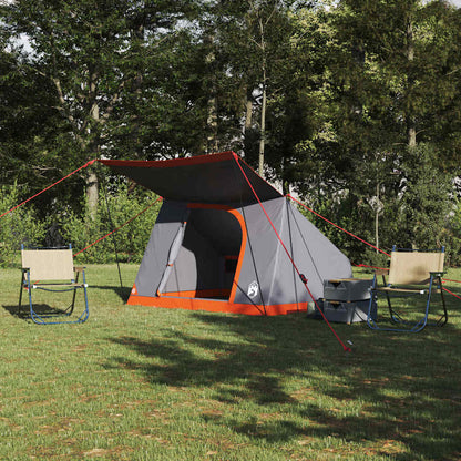 vidaXL campingtent in grijs en oranje met luifel, geplaatst op gras met twee stoelen.