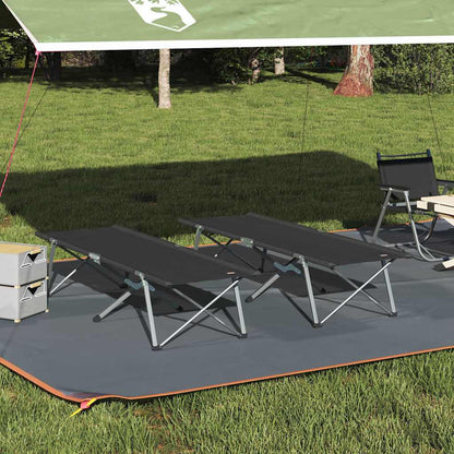 Opvouwbaar vidaXL camping bed in zwart, geplaatst onder een tentdoek op gras.