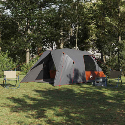 Dome tent vidaXL voor 4 personen in grijs en oranje, opgezet in een groene omgeving.