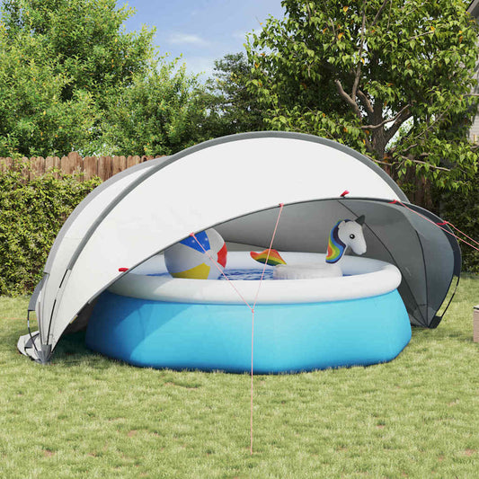 vidaXL Pooldome in grijs en oranje, opgevouwen boven een opblaasbaar zwembad in de tuin.