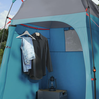 Detail van de binnenkant van de vidaXL Instant Tent met hangende kleding en een lamp.